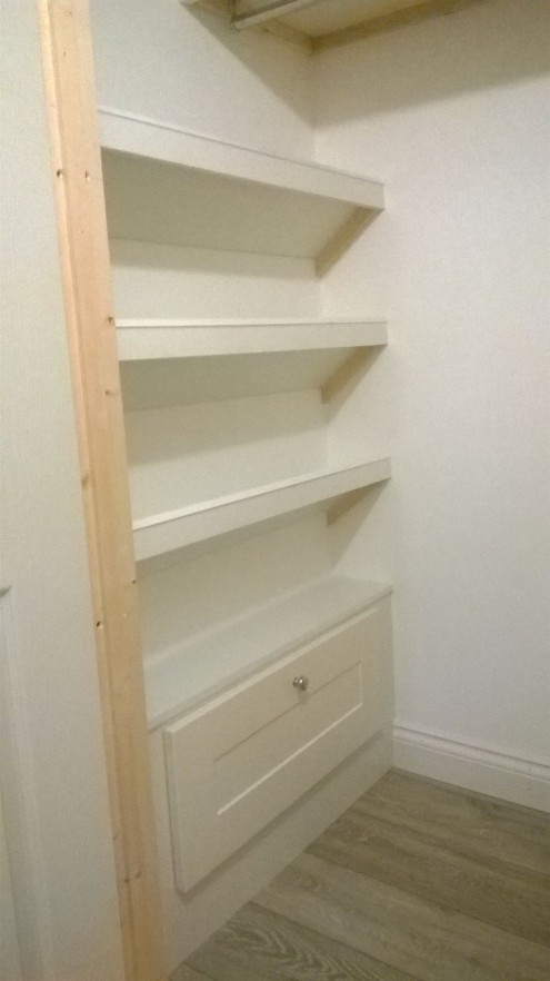 Hallway cupboard with recess shelving and built in shoe racks